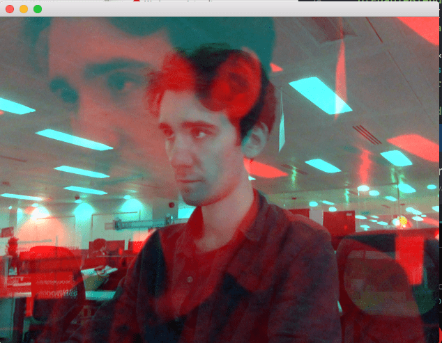 Struan appears with a blue hue in an office. A larger image with a red hue appears super imposed over the original image. Struan is looking pensive.