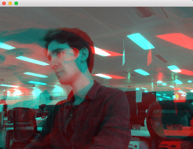 Struan appears with a blue hue in an office. A larger image with a red hue appears stretched and super imposed over the original image. Struan is confused.