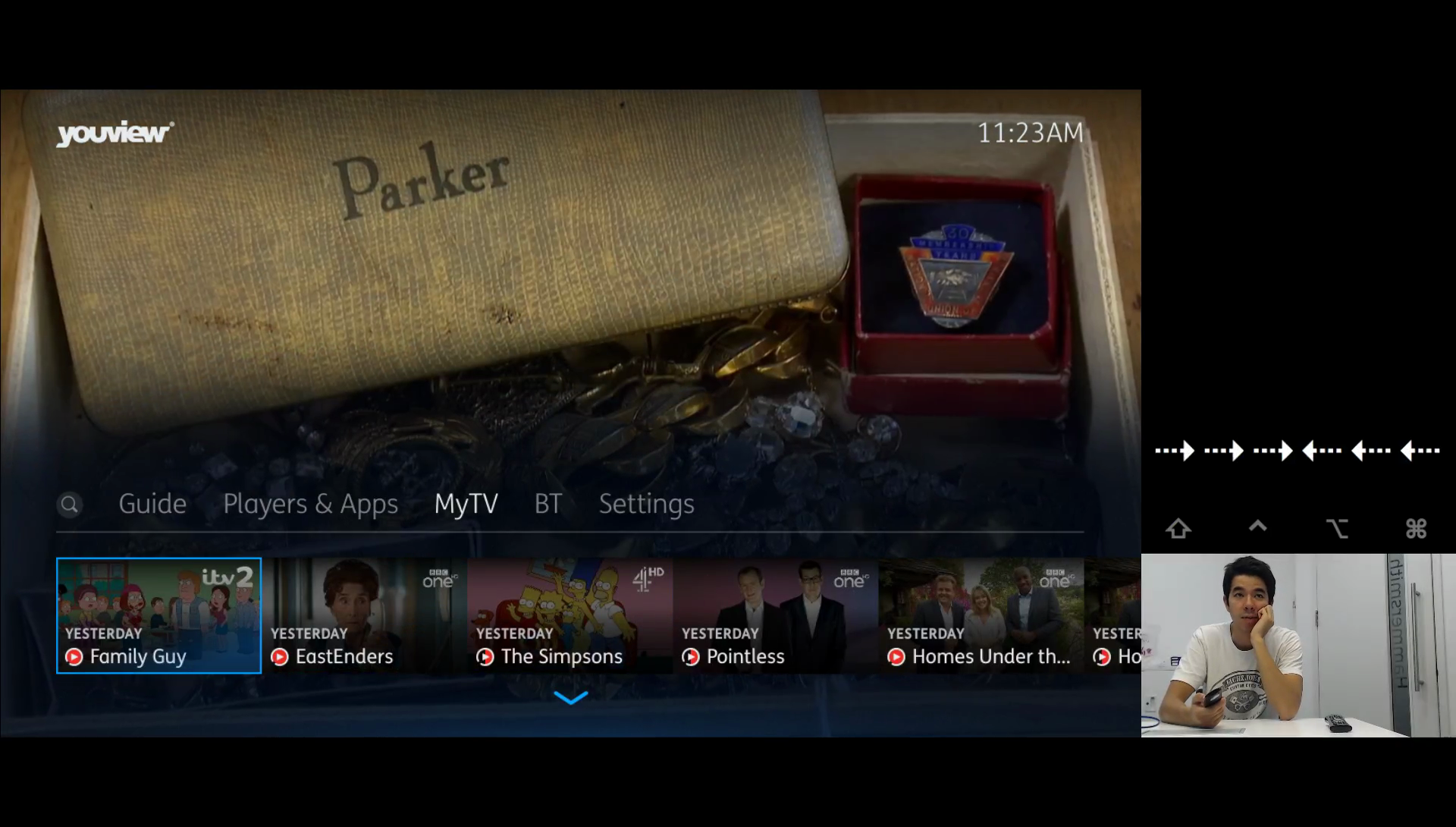 A young man using a main menu prototype with his key input shown to the side