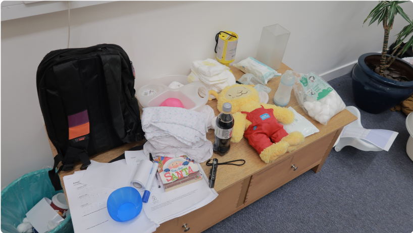 A table full of toys, cotton buds and cleaning paraphernalia